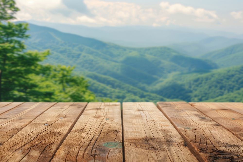 Wooden table background on a blur high green hills mountain wood architecture countryside.