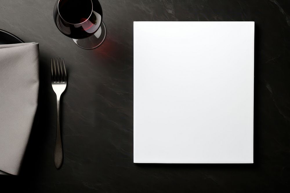 Paper white blank menu card on white plate furniture cutlery napkin.