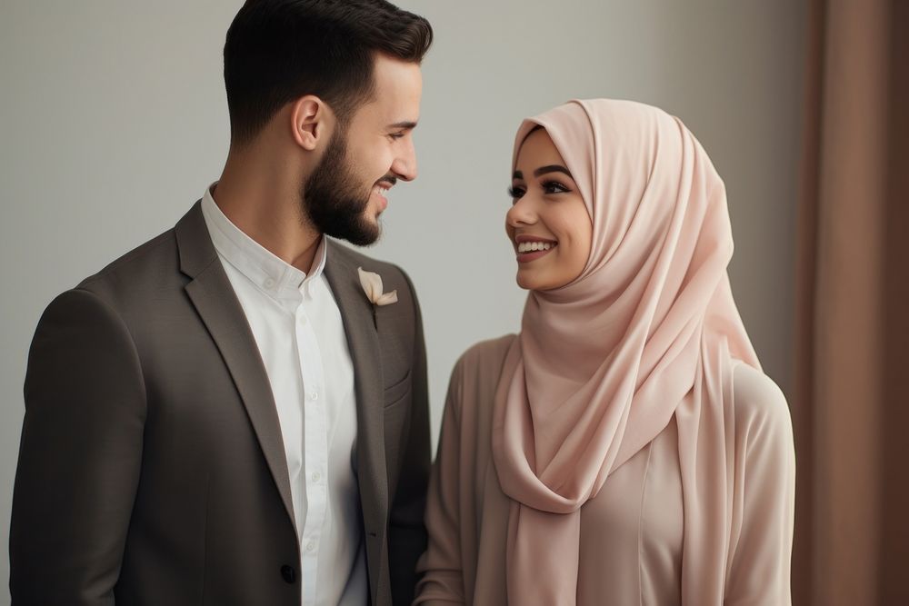Muslim couple newlywed looking at each other bridegroom clothing apparel.