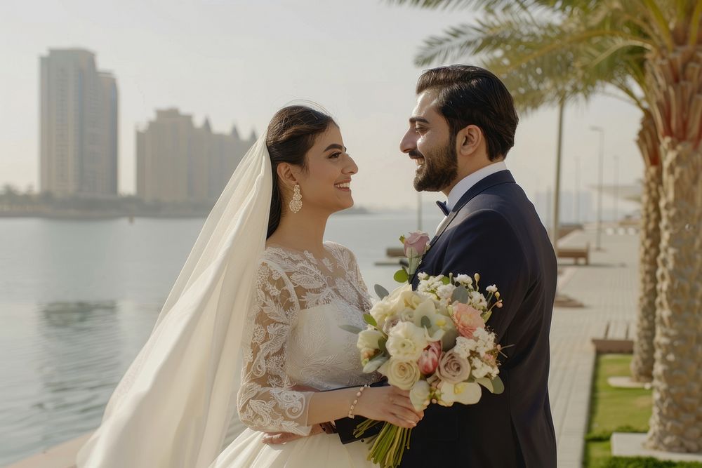 Arabic couple newlywed looking at camara wedding bridegroom clothing.