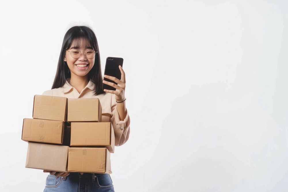 Happy teenager holding stack box cardboard phone photo.