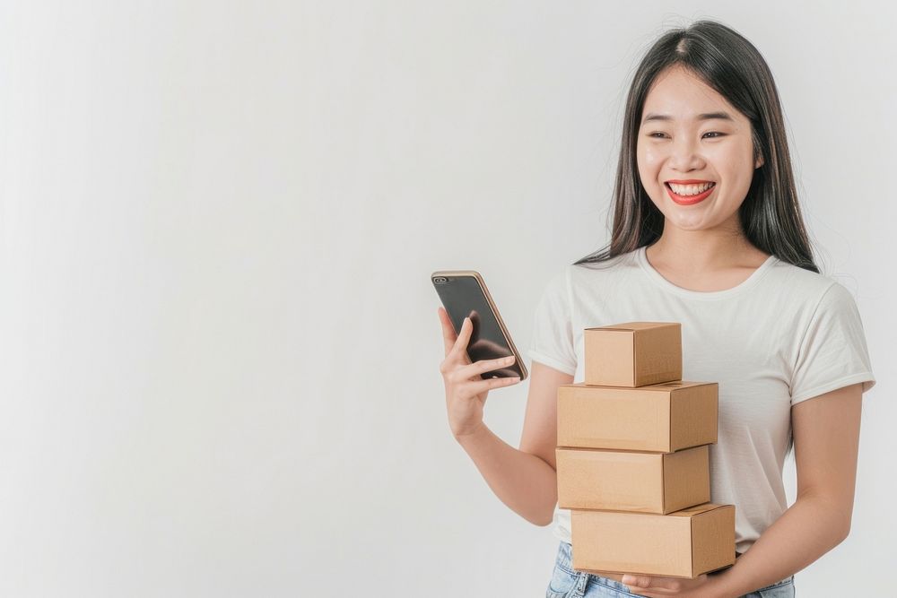 Happy woman holding stack box cardboard mobile phone portability.