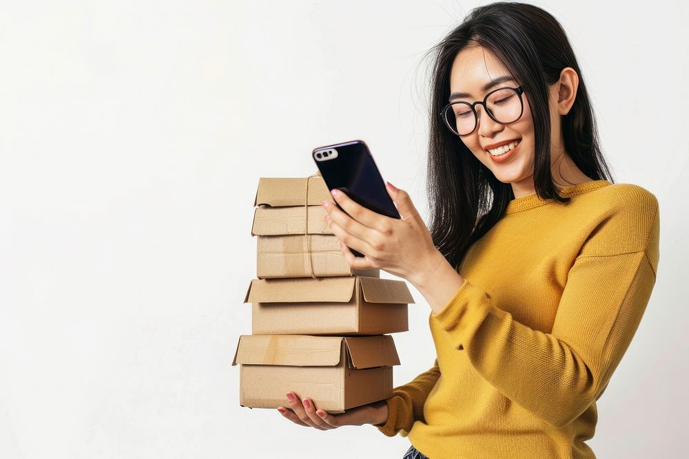 Happy woman holding stack box cardboard glasses phone.