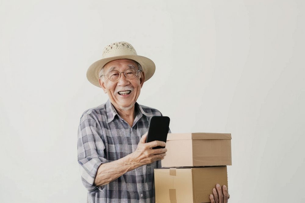 Happy senior holding stack box adult mobile phone portability.