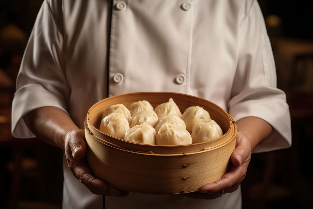 Chef holding a freshly cooked dimsum dumpling person adult.