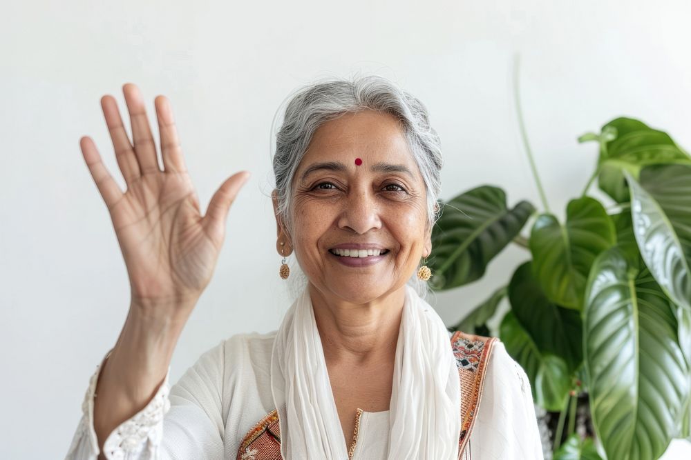 Senior indian woman waving hand smile clothing wedding.