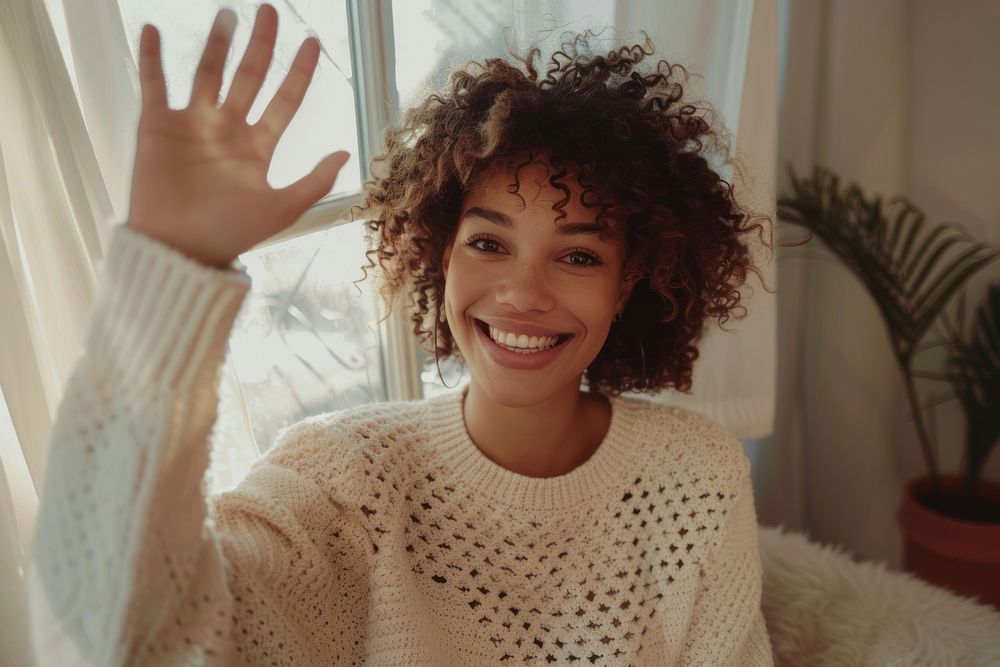 Woman waving smiling sweater clothing knitwear.