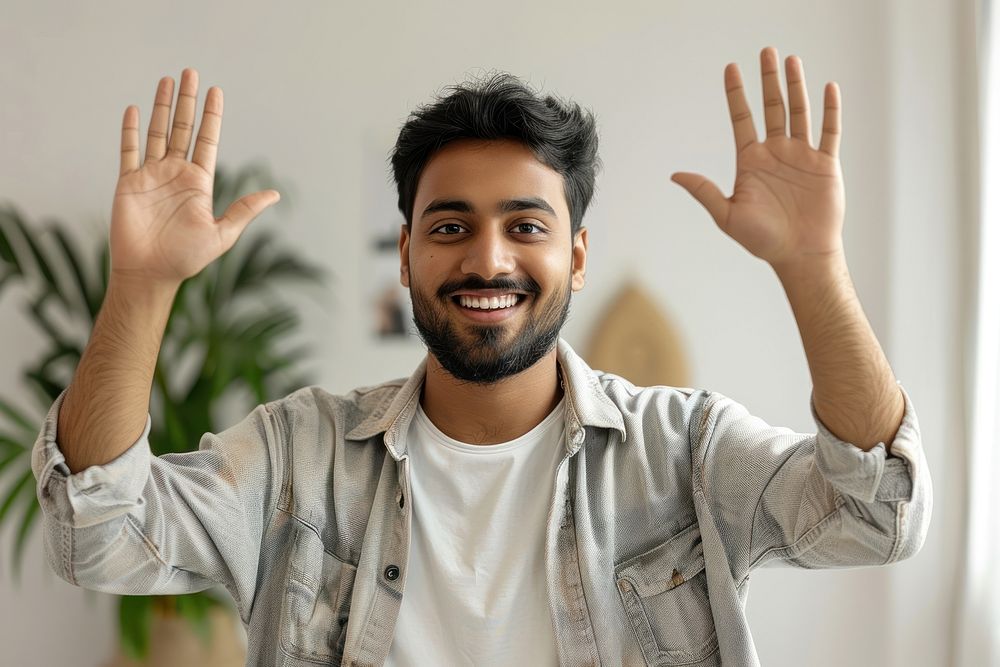 Young indian man waving hand smile dimples person.