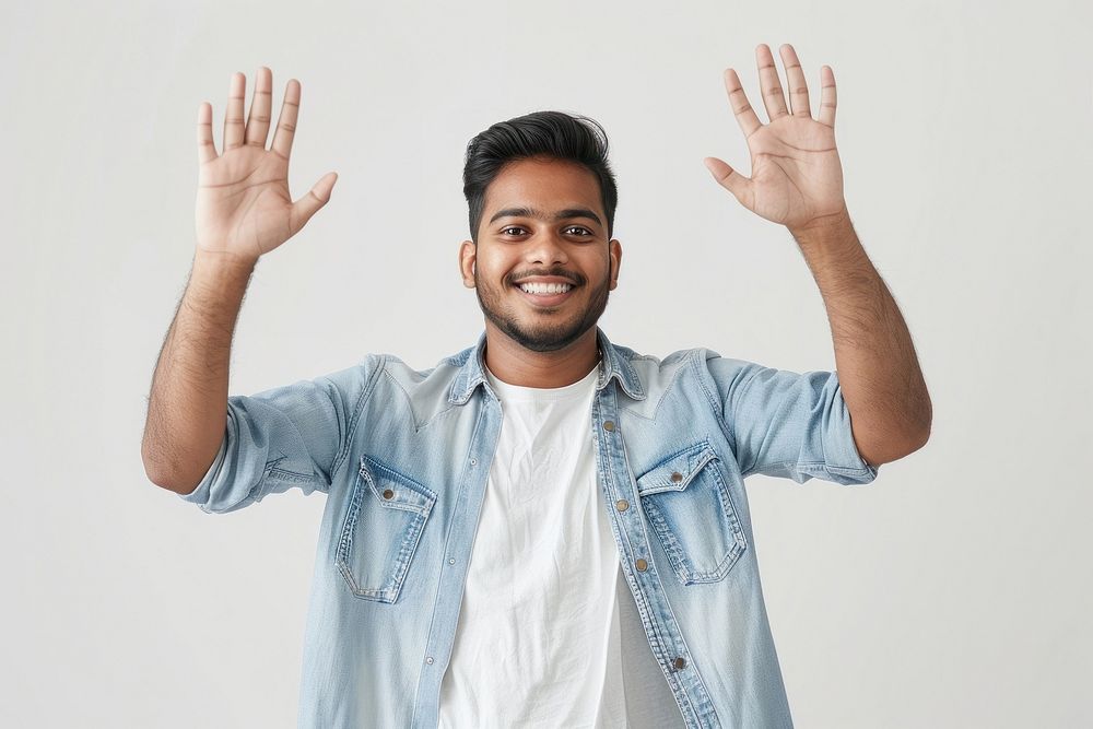 Young indian man waving hand smile triumphant person.