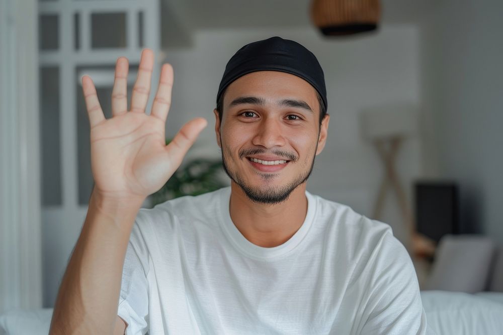 Young muslim man waving hand smile clothing dimples.
