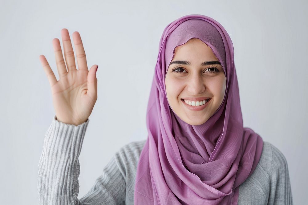 Young muslim woman waving hand smile clothing apparel.
