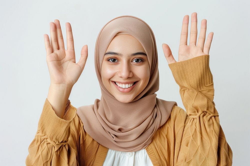 Young muslim woman waving hand smile clothing apparel.