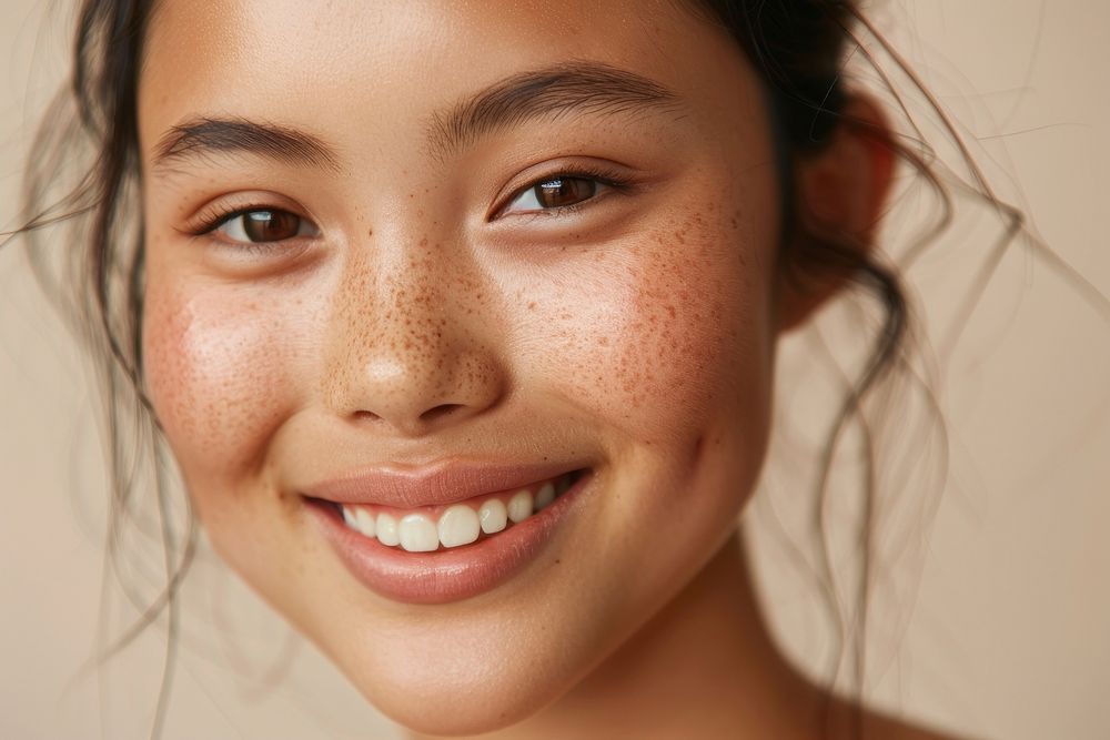South East Asian women face with no makeup happy skin person.