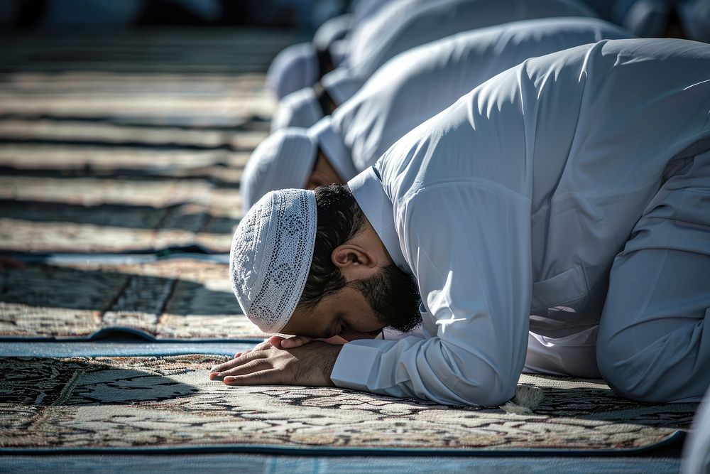 Muslim men in white robe prayer head worship.