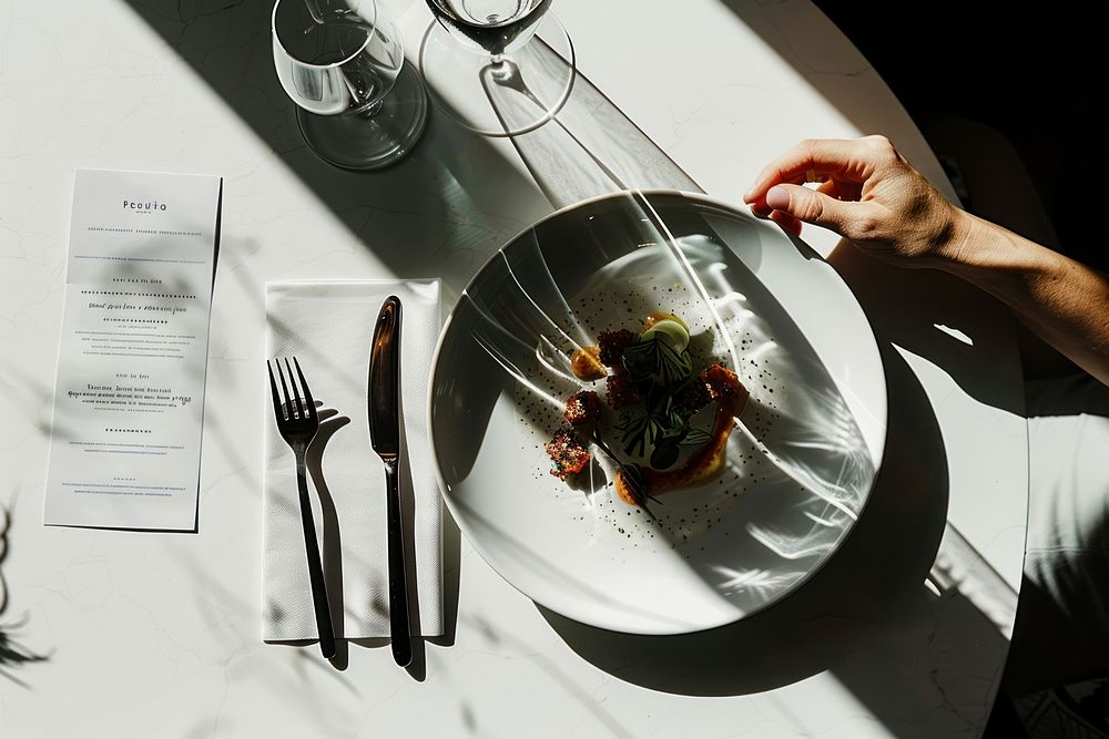 A modern restaurant menu plate food cutlery.