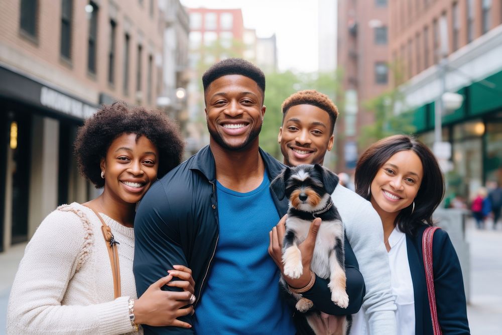 Black family and someone holding puppy laughing street adult.