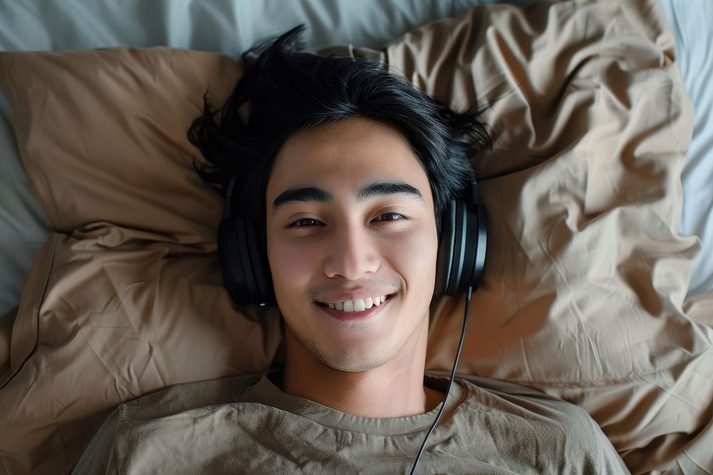 South asian man headphones person smile.