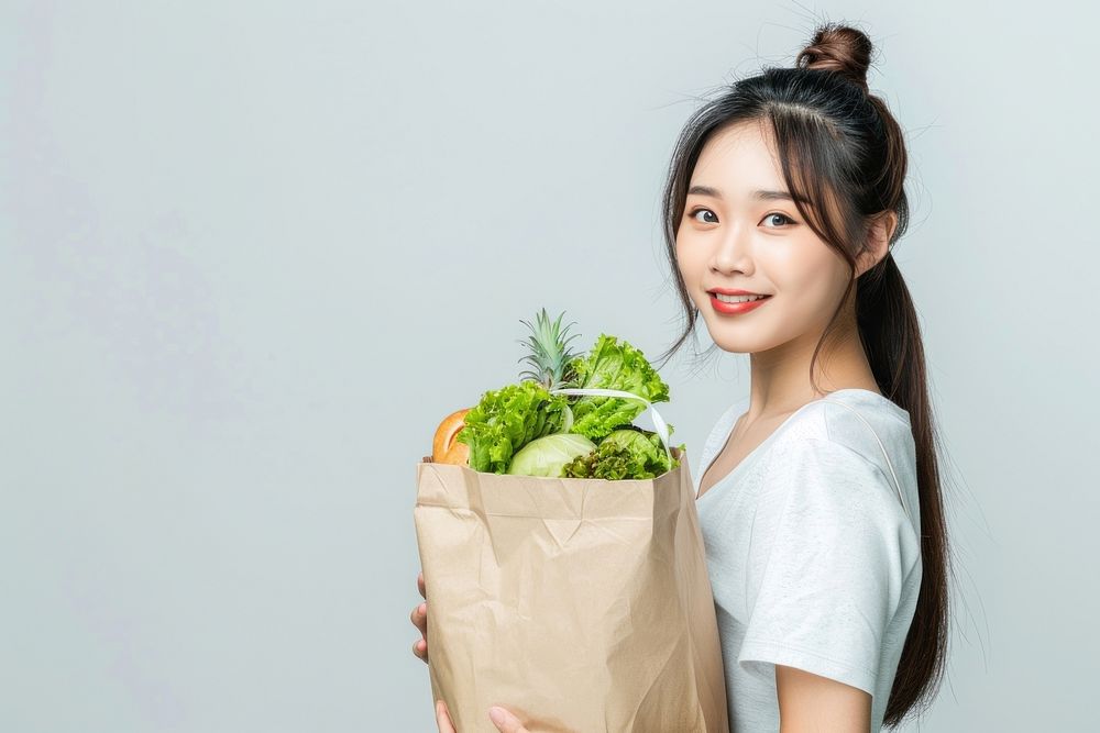 Young south east asian women food bag pineapple.