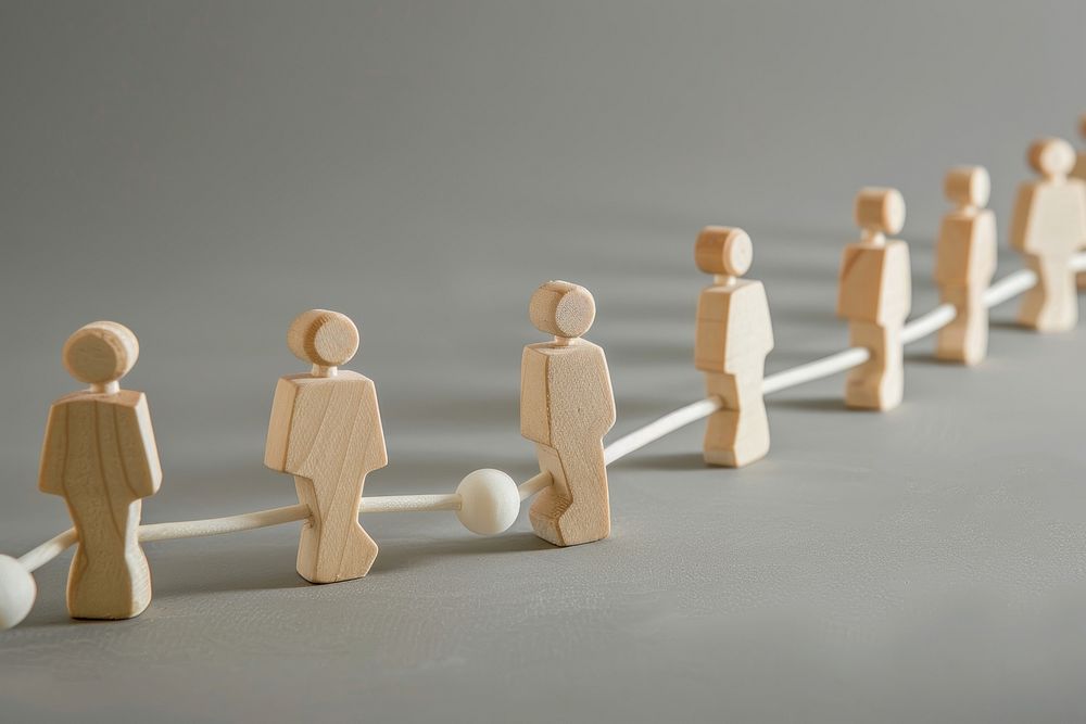 Chain of people figurines connected by white lines chess game toy.
