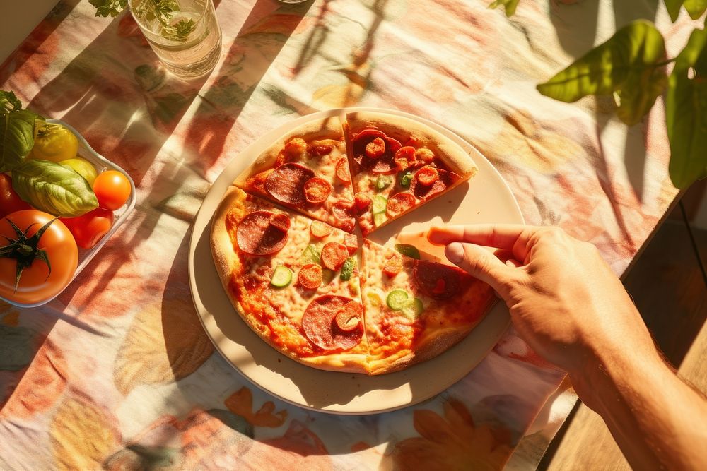 Person holding appetizing pizza fresh lettuce ham table.