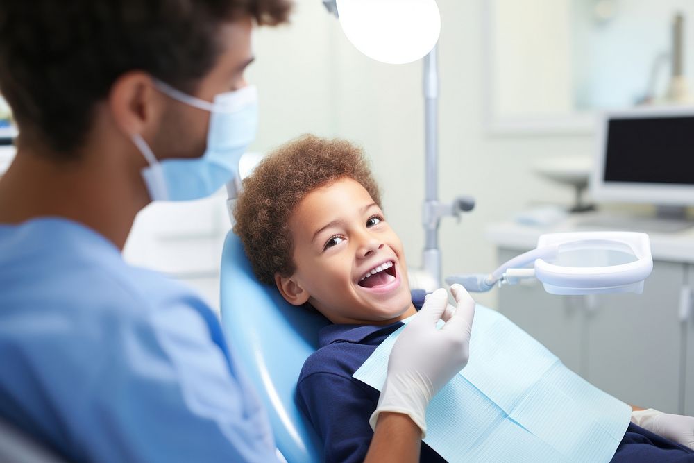 Close up of boy having his teeth examined by a dentist electronics clothing hardware.