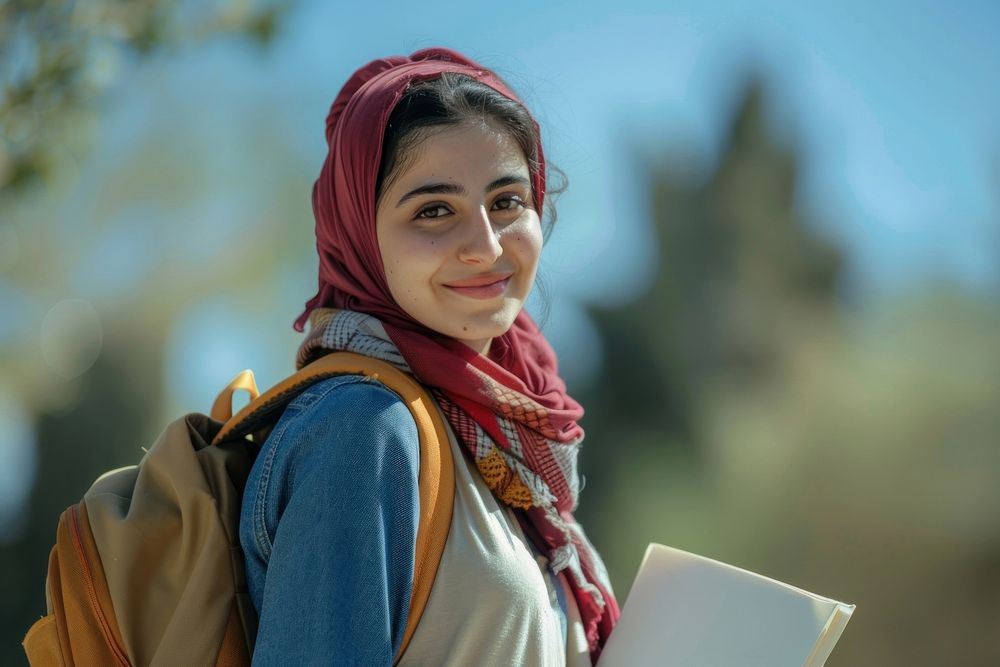 Young Iranian Female Student Standing Outdoors With Workbooks In Hands clothing apparel dimples.