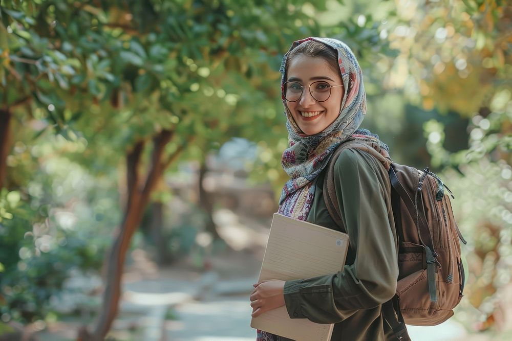 Young Iranian Female Student Standing Outdoors With Workbooks In Hands female accessories accessory.