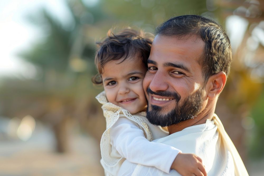 Happy middle eastern child enjoying ride on father back outdoor photo happy man.