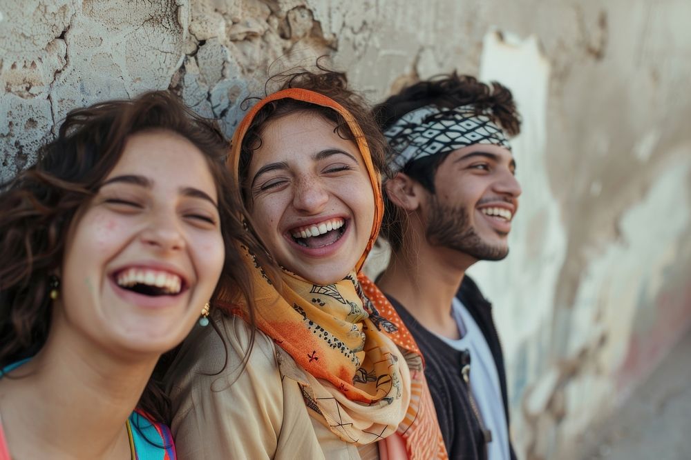 Happy middle eastern laughing with teenage female and male friends happy clothing apparel.