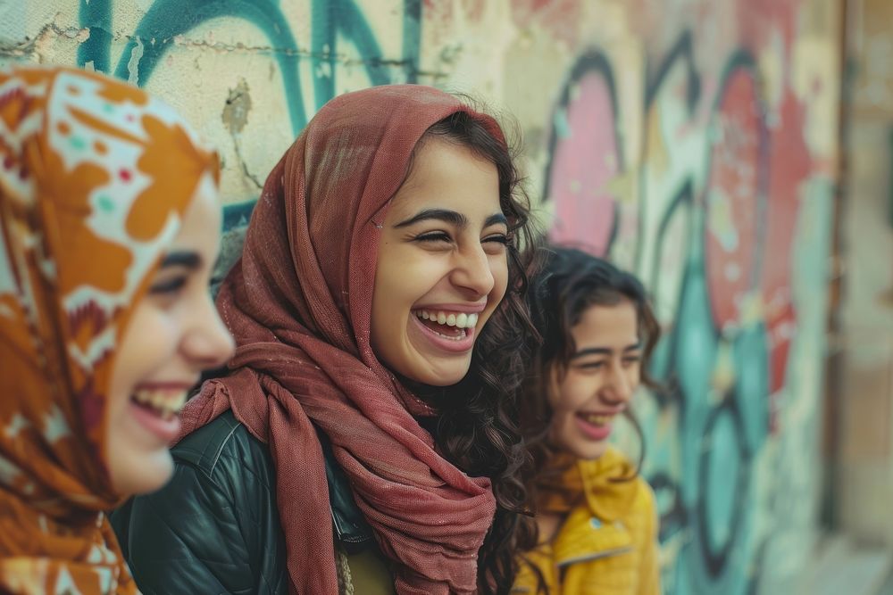 Happy middle eastern laughing with teenage female friends happy clothing apparel.