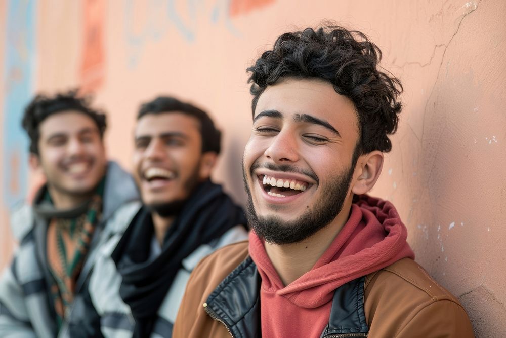 Happy middle eastern laughing with teenage male friends happy clothing apparel.