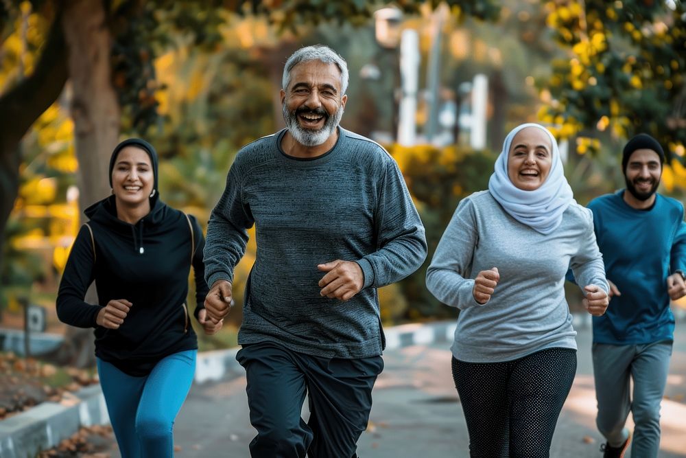 Healthy group of middle eastern aged men and women jogging at park running happy sweatshirt.