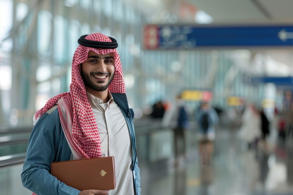 Portrait Of Young Middle Eastern Male Traveller Posing At Airport electronics executive clothing.