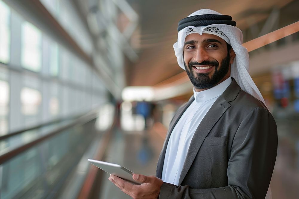 Smiling Young Middle eastern With Digital Tablet In Hands Posing At Airport Terminal man executive dimples.