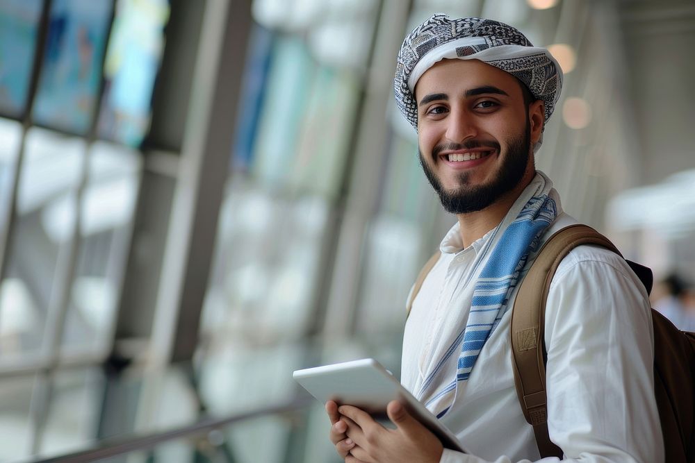 Smiling Young Moroccan With Digital Tablet In Hands Posing At Airport Terminal man backpack dimples.