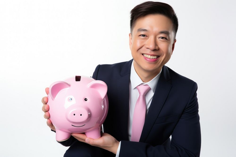 Happy Asian businessman holding pink piggy bank accessories accessory clothing.