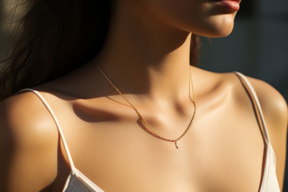 Model brunette in modern gold metal necklace chain accessories accessory shoulder.