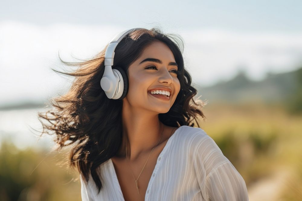 South asian teen woman headphones person smile.