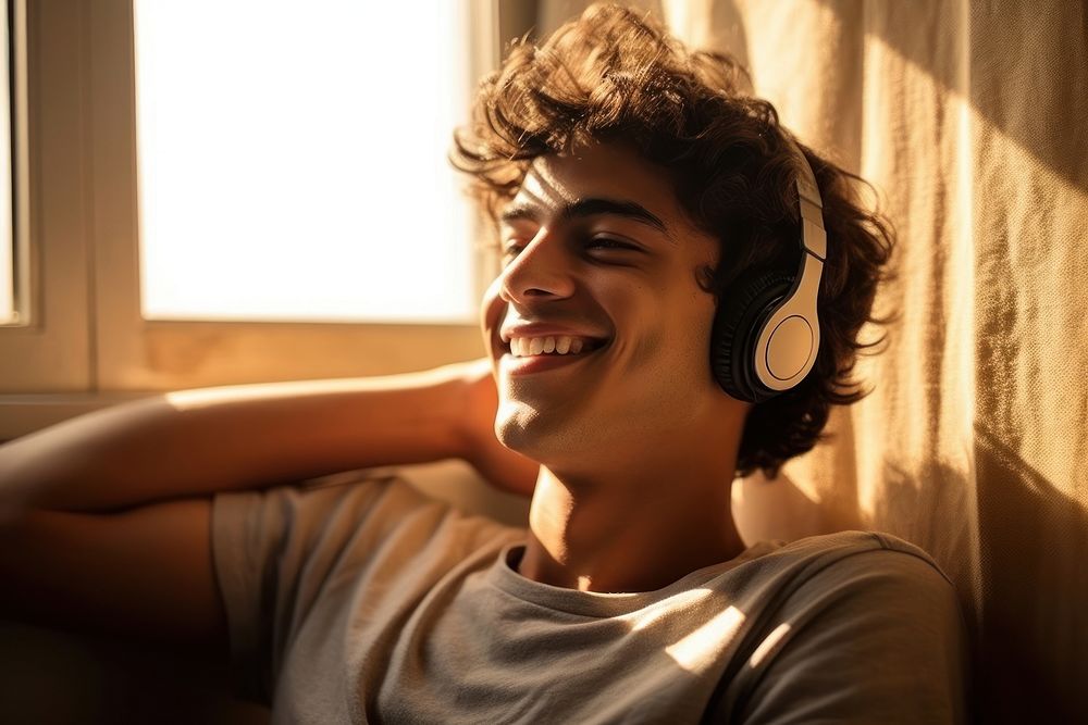 South asian teen man headphones person smile.