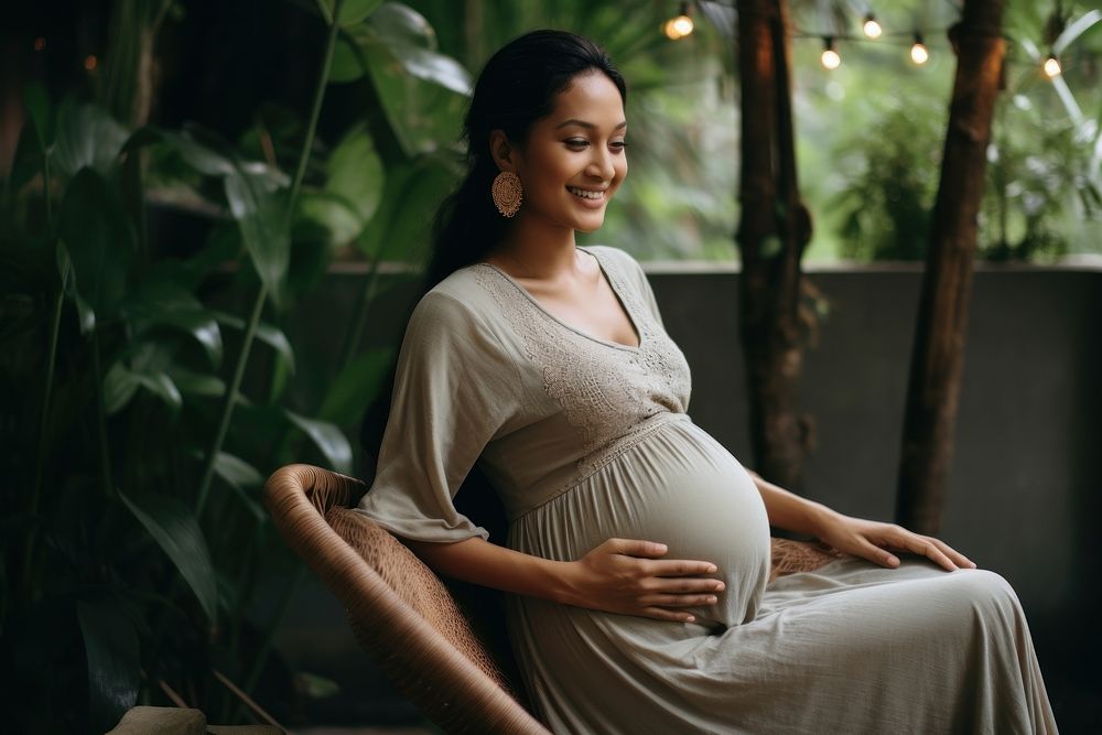 Pregnant woman sitting clothing apparel.