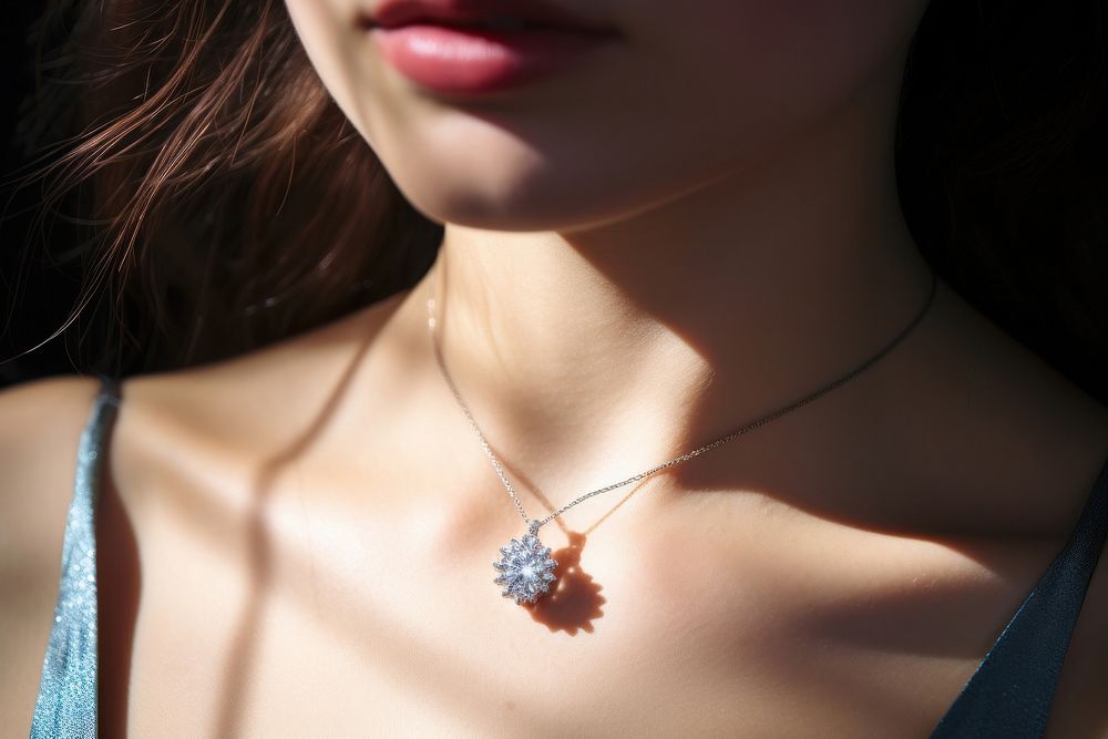 Young woman wearing shiny diamond pendant accessories accessory necklace.