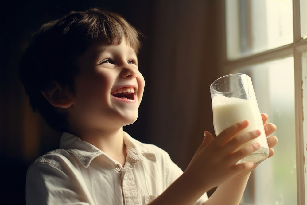 Child holding a glass of milk photo photography beverage.