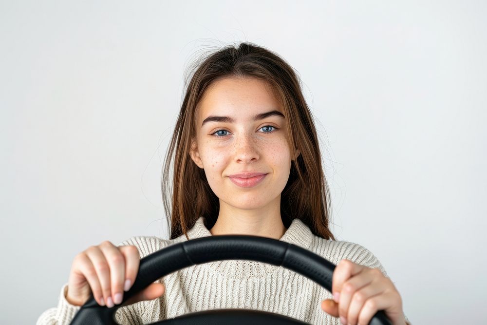 Woman holding a car steering wheel portrait vehicle driving.