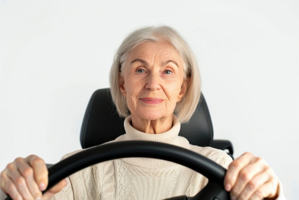 Elder woman holding a car steering wheel portrait vehicle driving.