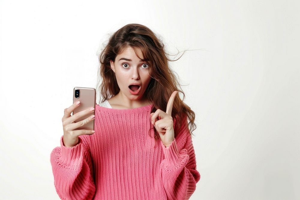 Young woman with shocking face sweater camera hand.