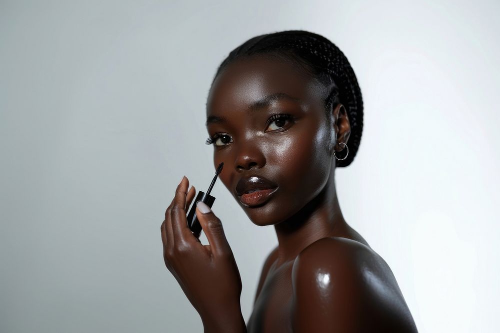 Woman face applying serum skin cosmetics lipstick.