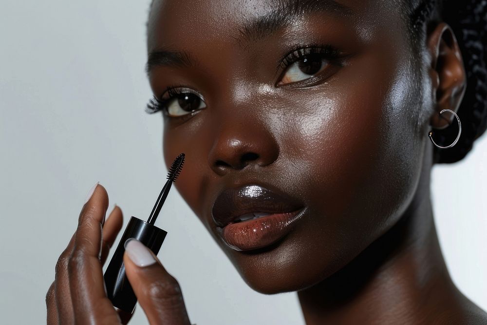 Woman face applying serum skin cosmetics black.