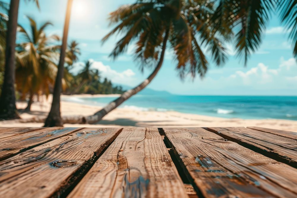 Empty wooden table in front of beach ocean sunlight outdoors.
