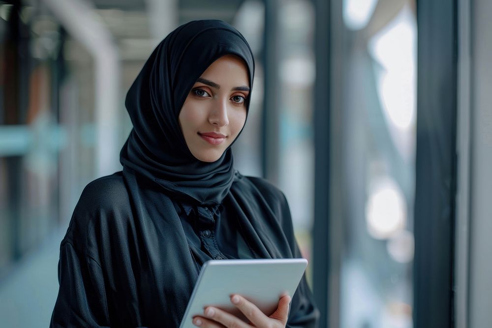 Woman using tablet hijab portability technology.