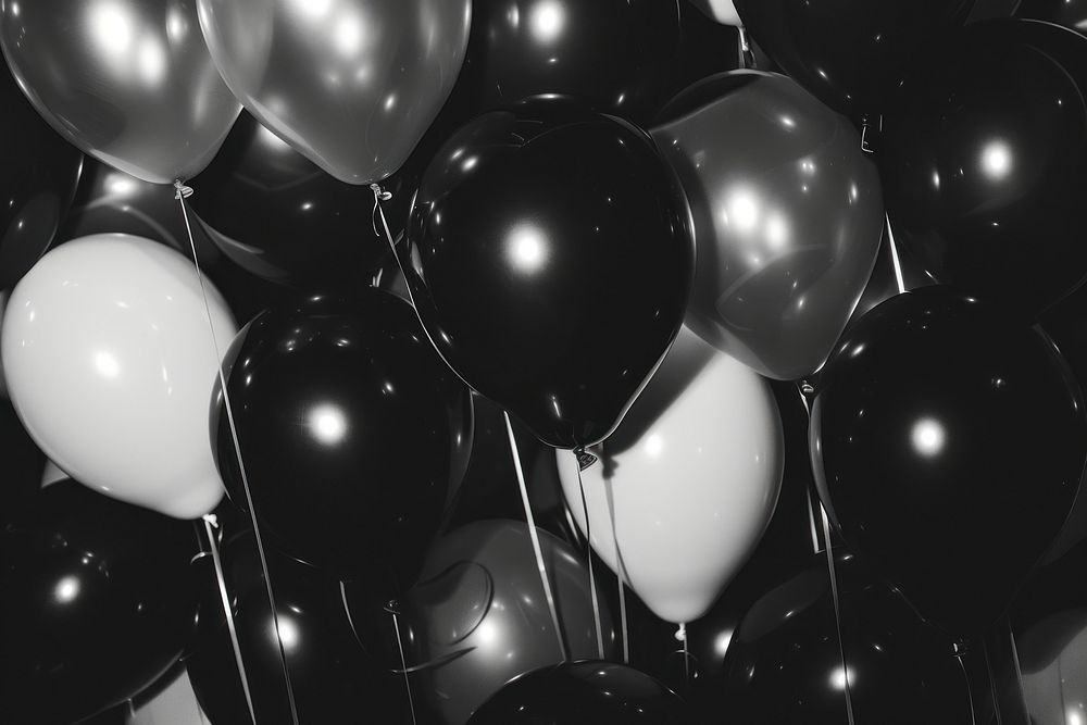 Black and white balloons illuminated backgrounds celebration.